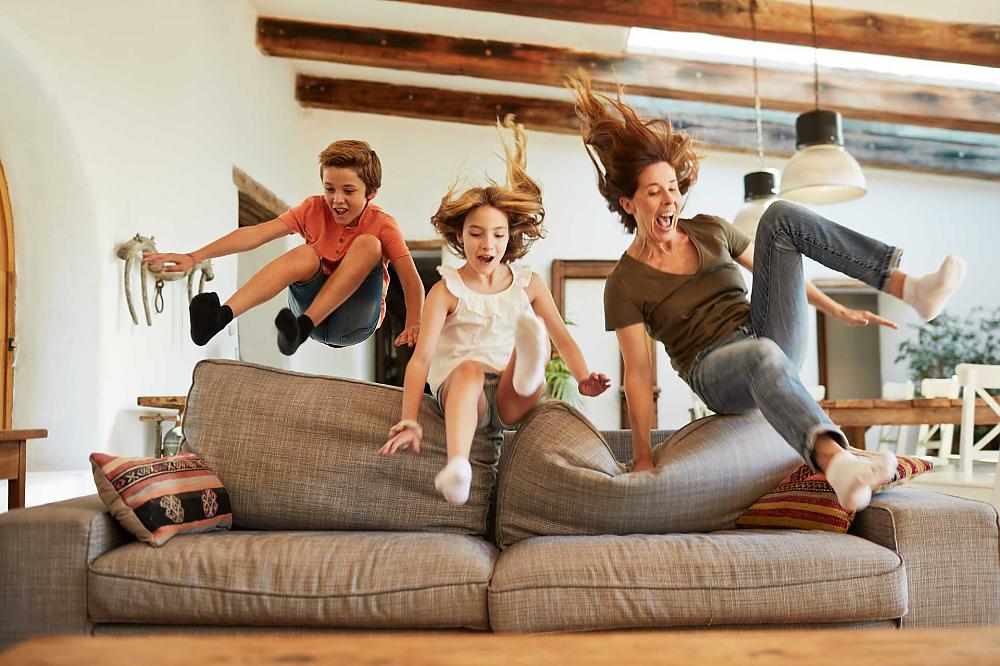 Family jumping on couch