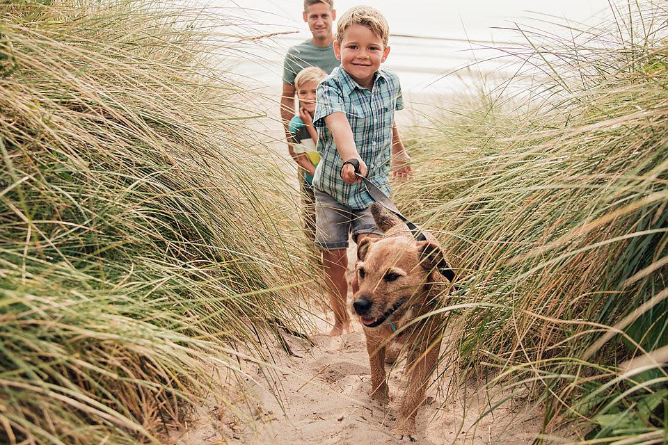 Boy walking his dog on trail